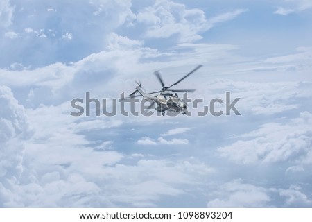 Helicopter Thai army is flying over the clouds.