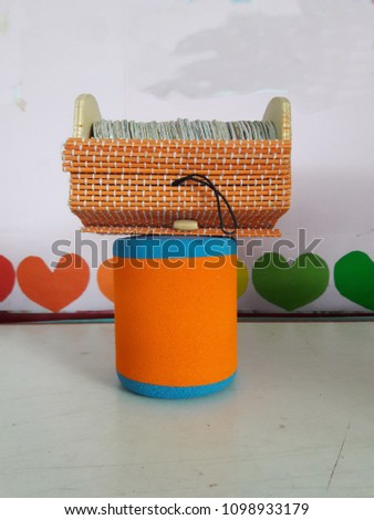 Card Case Made with orange woven mat.
Medium of instruction for young children.