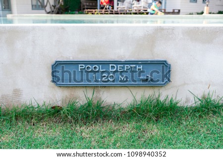 warning pool depth sign by swimming pool in modern resort for safety