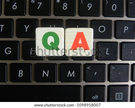 Word QA (Quality Assurance) on keyboard background