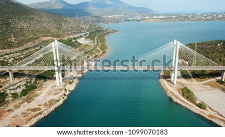 Aerial drone bird's eye view of suspension bridge connecting an island to mainland