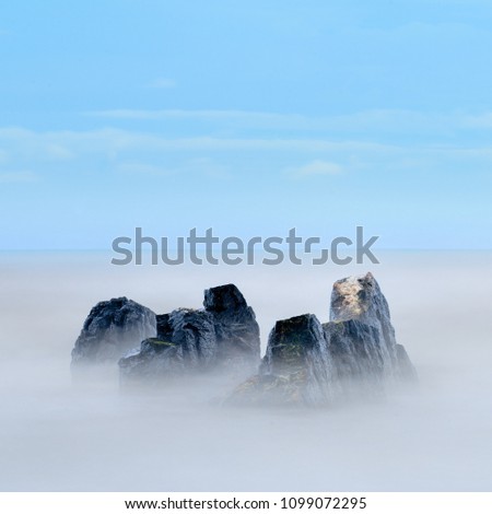 Long exposure photo of rocky beach in the evening, minimalist photography