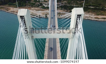 Aerial drone bird's eye view of suspension bridge connecting an island to mainland