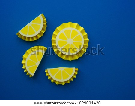 Fruit made of paper. Blue background. There's room for writing.Tropics. Flat lay. Lemon and orange.