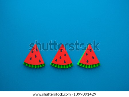 Fruit made of paper. Blue background. There's room for writing.Tropics. Flat lay.Watermelon