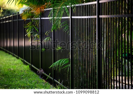 Black Aluminum Fence Royalty-Free Stock Photo #1099098812