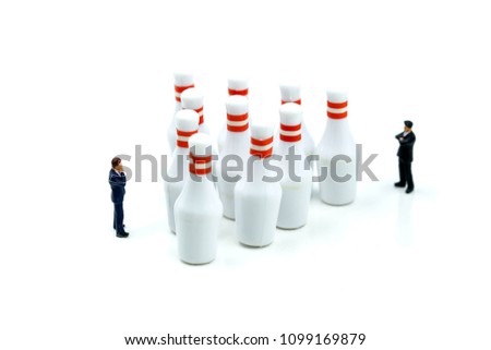 Miniature people : businessman with bowling pin and ball,Business competition concept Fighting and confronting problems.