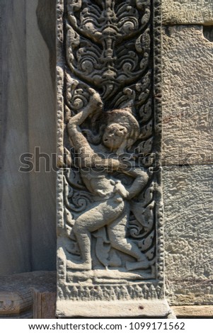 Ancient sculpture tracery on the sandstone pillar at Phimai historical park,Thailand.