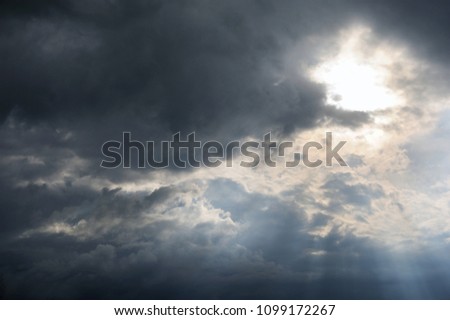 clouds with background,sunlight through very dark clouds background of dark storm clouds, black sky Background of dark clouds before a thunder.
