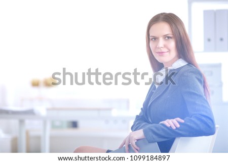 Portrait of business woman siting in office. Portrait of business woman.