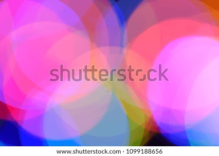 Blurred colorful circular facular on dark background.