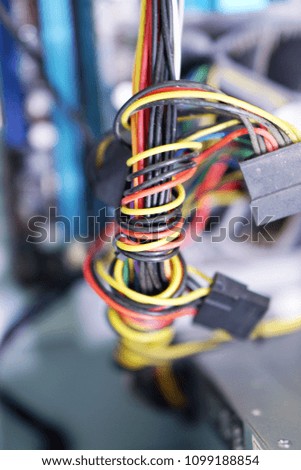 Power cord on computer waiting for repair.                     