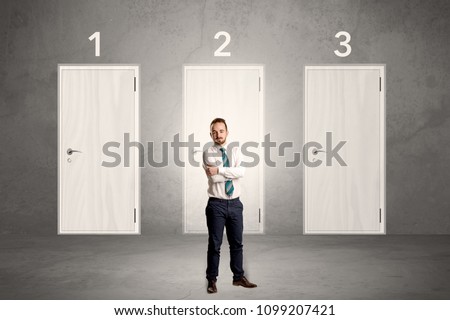 Businessman in grey room with three numbered white  door behind his back