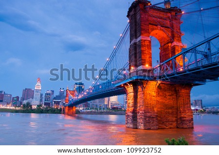 A beautiful aged bridge by the Cincinnati skyline