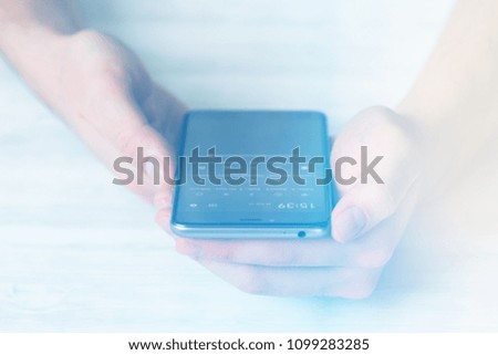 Hipster using a touch screen smart phone hands close up, vintage colors