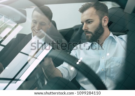 First test drive a new car. Handsome bearded man ready to make first test drive Royalty-Free Stock Photo #1099284110