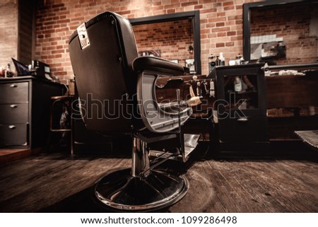 Client's stylish barber chair. barber shop for men Royalty-Free Stock Photo #1099286498