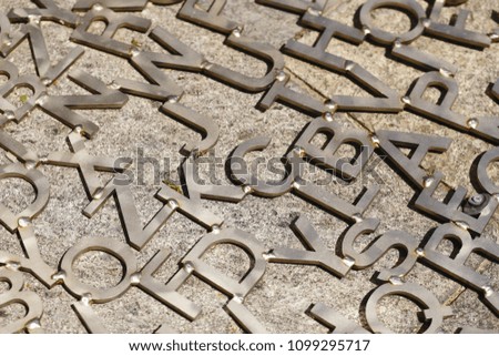 old metal letters on a gray background