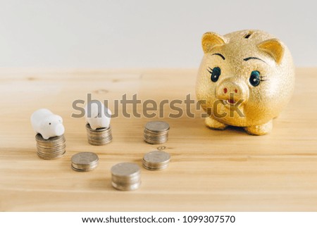 Golden piggy bank and Korean money coins on wooden desk
