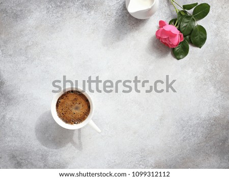 Coffee. Happy morning with cup of coffee and pink rose. Overhead view, copy space.