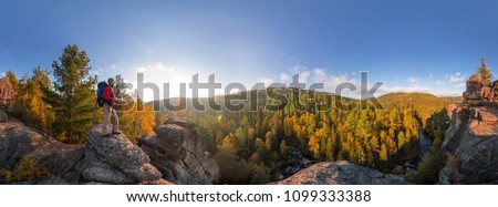 Backpacker on top of a rock fall at dawn. Cylindrical panorama 360 degrees Royalty-Free Stock Photo #1099333388