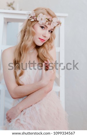 picture of young blonde woman wearing wreath of flowers, spring tender and romantic portrait