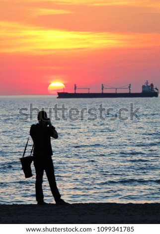 photographer photographing a beautiful sunset