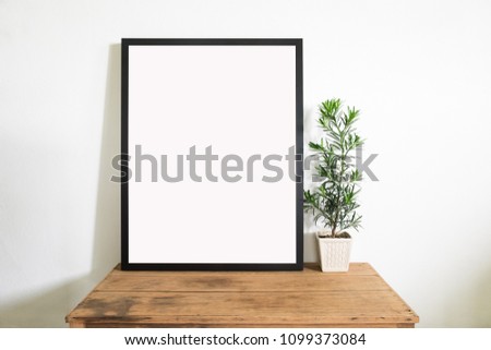 Mock up frame poster with houseplant on old wooden table in room