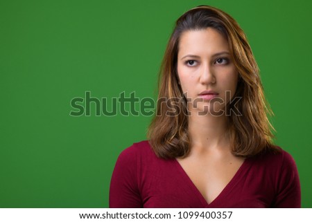 Studio shot of young beautiful multi-ethnic woman against chroma key with green background