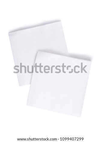 Group of white closeup square papper napkins isolated on white background