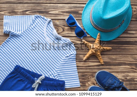Flat lay picture of child`s summer clothes