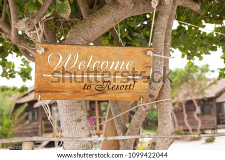 signboard with the word welcome, resort, relax