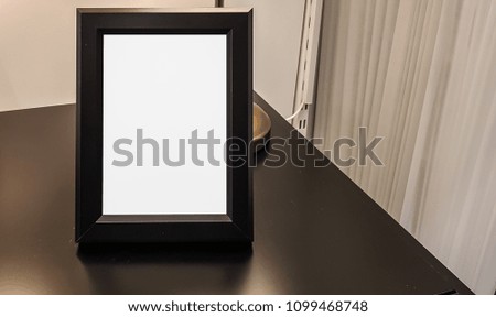 Empty Modern Black Frame On The Dark Wooden Table.Blank Advertisement Banner Poster Mock Up.Isolated Template Clipping Path