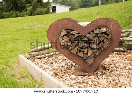 Metallic decor heart filled with wood.
