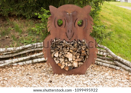 Metallic decor owl filled with wood.