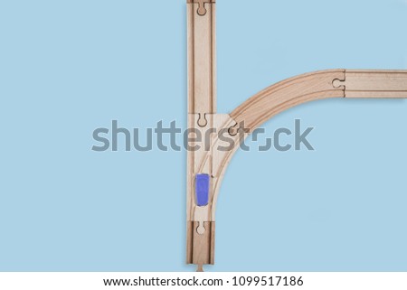 Top view of isolated wooden tracks with a crossover on a white background. The concept of making difficult decisions, changes in life. Time for changes. It will face a dilemma.