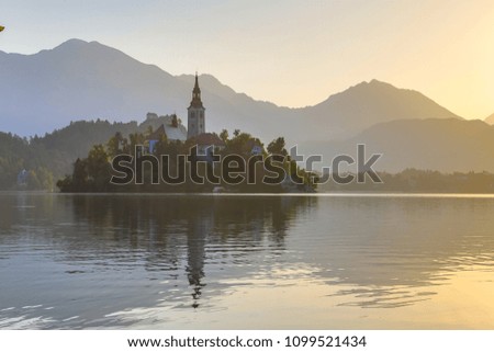 Island with church in lake Bled on hazy morning Slovenia Europe