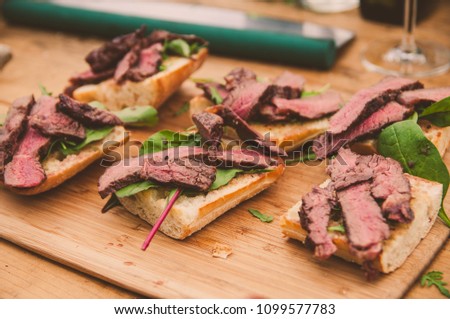 Grilled piece of steak on salad and toasted bread
