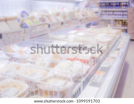 Defocused background with shelves full of grocery goods in a supermarket or hypermarket convenience store. Intentionally blurred post production for bokeh effect