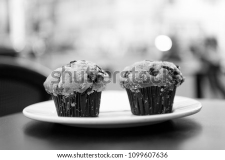 Cupcakes with blueberry on white plate in paris, france on blurred background. 