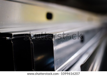Close up of aluminium profile stacked steel background. industrial texture construction concept. Copy space. Stack of grey color metal reinforcing bundle, plant factory manufacture technology pattern