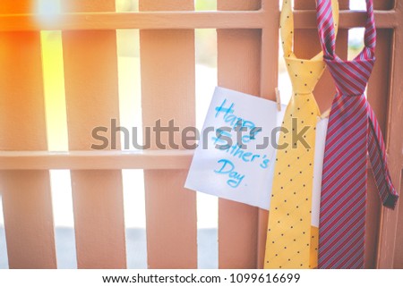 Everyday is father's day. Happy Father's day concept. yellow necktie, red necktie and the white paper written Happy Father's Day on the brown fence background.