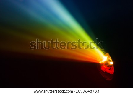 beautiful rainbow color wide lens projector with light beam for movie and cinema at night . smoke texture spotlight . screening for multimedia . black background . Royalty-Free Stock Photo #1099648733