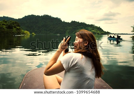 Asian woman taking photos of her surroundings