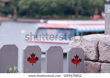 Happy Canada day on Wooden fence and a boat in background