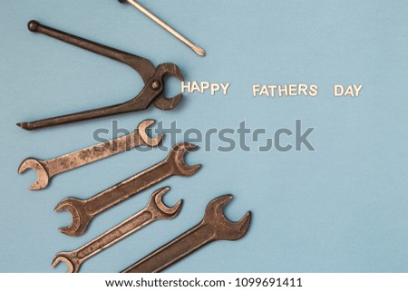 Father's day concept card with man's work tools on grey background and inscription Happy Father's Day. Top view.