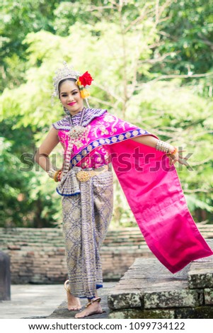 Asian woman wearing typical, traditional Thai Dress. It is literally means "Thai outfit", National costume.