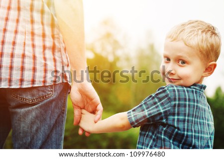 Father and son holding hand in hand Royalty-Free Stock Photo #109976480