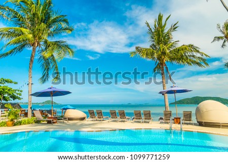 Umbrella and chair around swimming pool in hotel and resort for travel and vacation