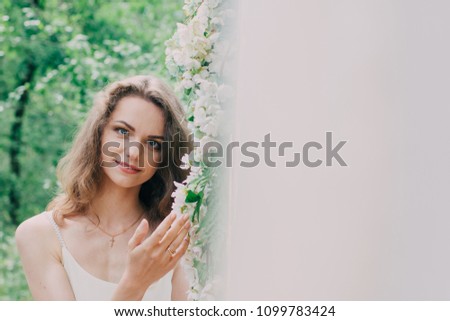 Very beautiful girl photographed in nature with fresh flowers.